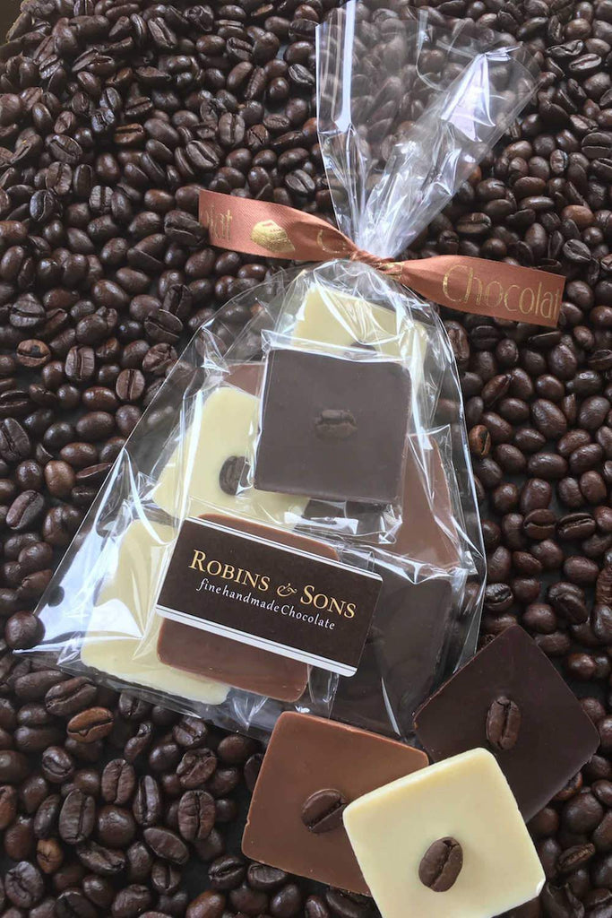 Individually wrapped Belgian milk white and dark chocolate squares topped with italian coffee beans