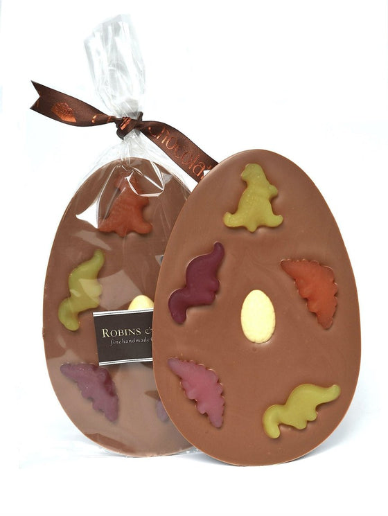 Dinosaur Easter egg in clear packaging tied with ribbon