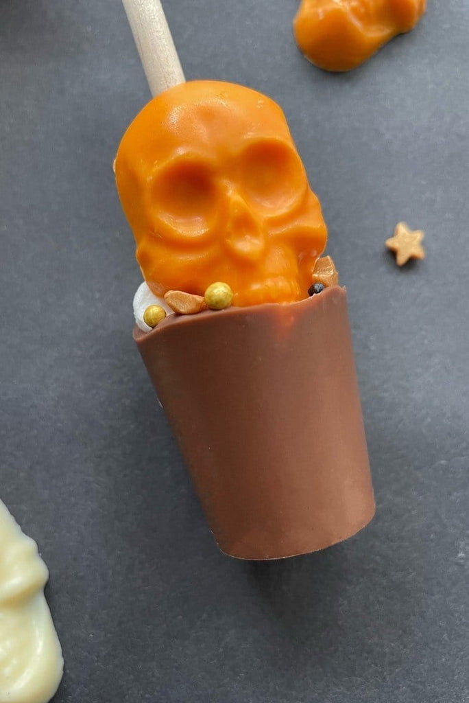 milk chocolate hot chocolate stirrer with orange chocolate skull