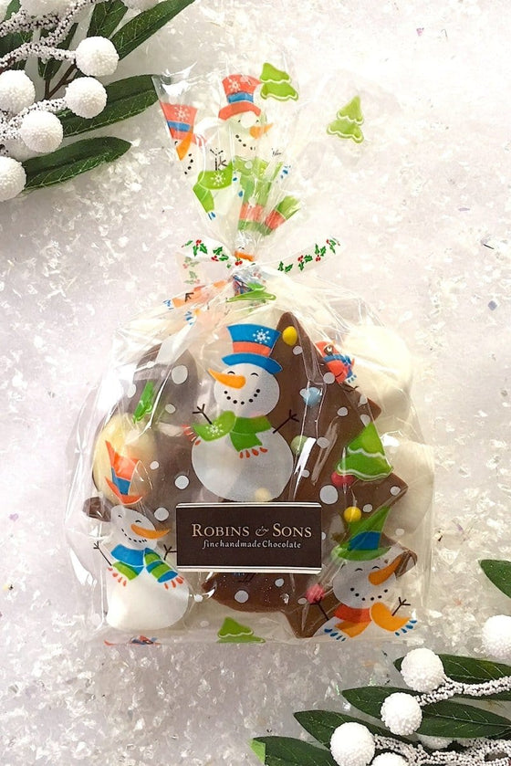 Goody bag filled with marshmallows, a chocolate Christmas tree and solid milk and white chocolate penguin