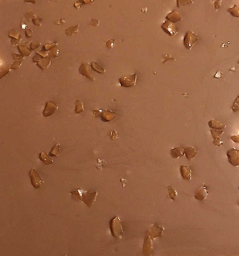 close up of milk chocolate with salted caramel pieces and sea salt flakes
